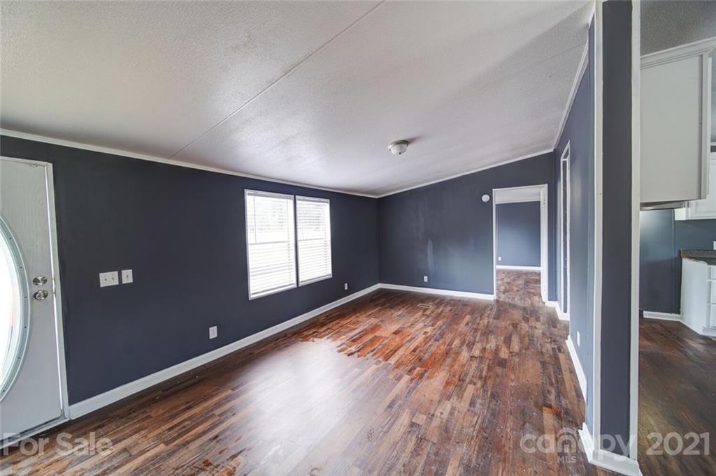 283 Ballard Spring Road, Unit 3276 Morven, NC 28119 - Photo 33 of 48 a view of empty room with wooden floor and fan