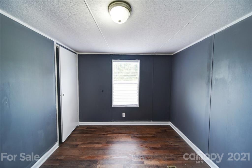 283 Ballard Spring Road, Unit 3276 Morven, NC 28119 - Photo 37 of 48 an empty room with wooden floor and window