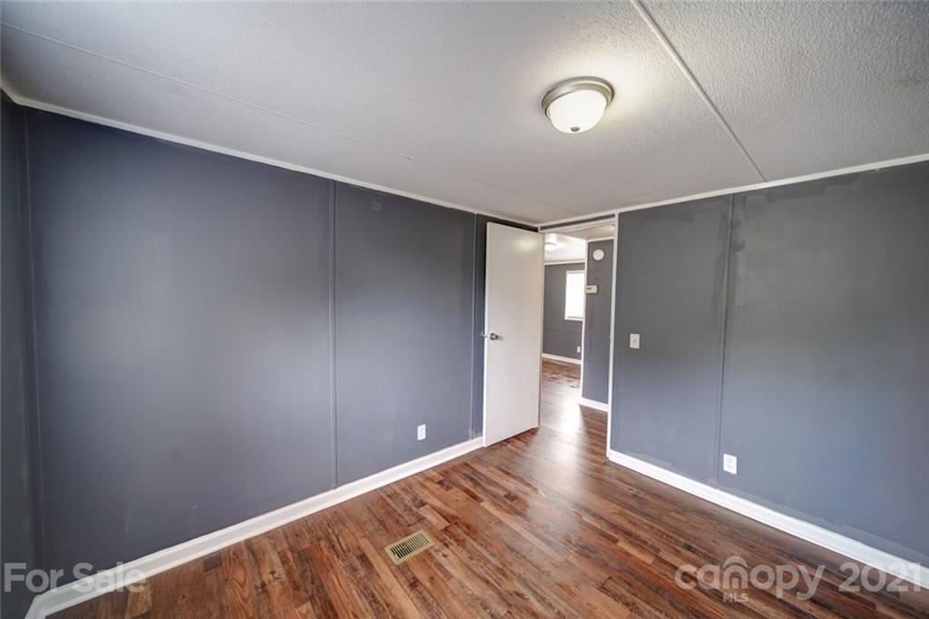 283 Ballard Spring Road, Unit 3276 Morven, NC 28119 - Photo 39 of 48 a view of an empty room with wooden floor