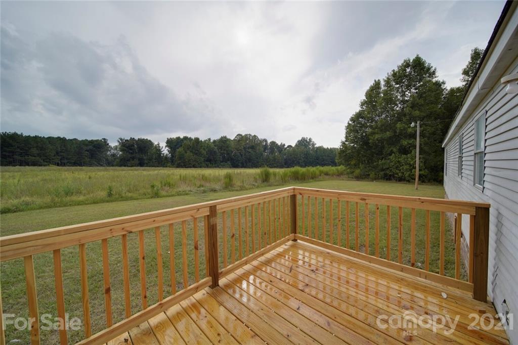 283 Ballard Spring Road, Unit 3276 Morven, NC 28119 - Photo 5 of 48 a view of deck and lake with trees in the background