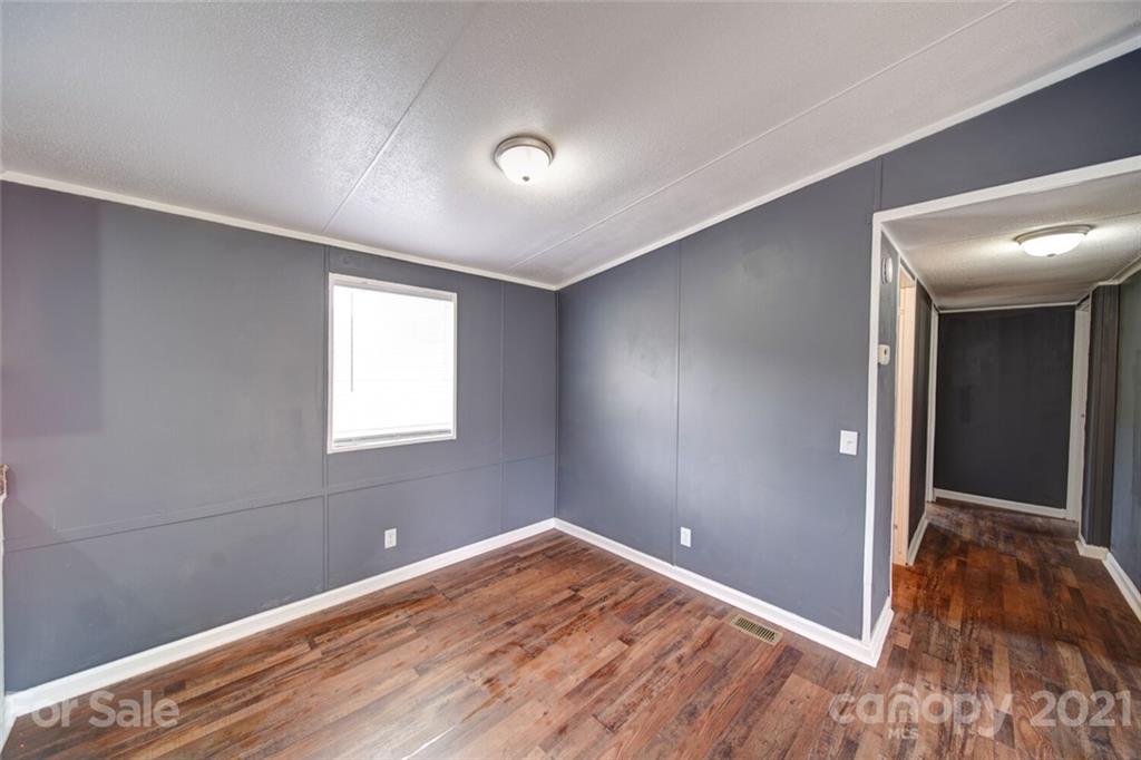 283 Ballard Spring Road, Unit 3276 Morven, NC 28119 - Photo 43 of 48 an empty room with wooden floor and windows