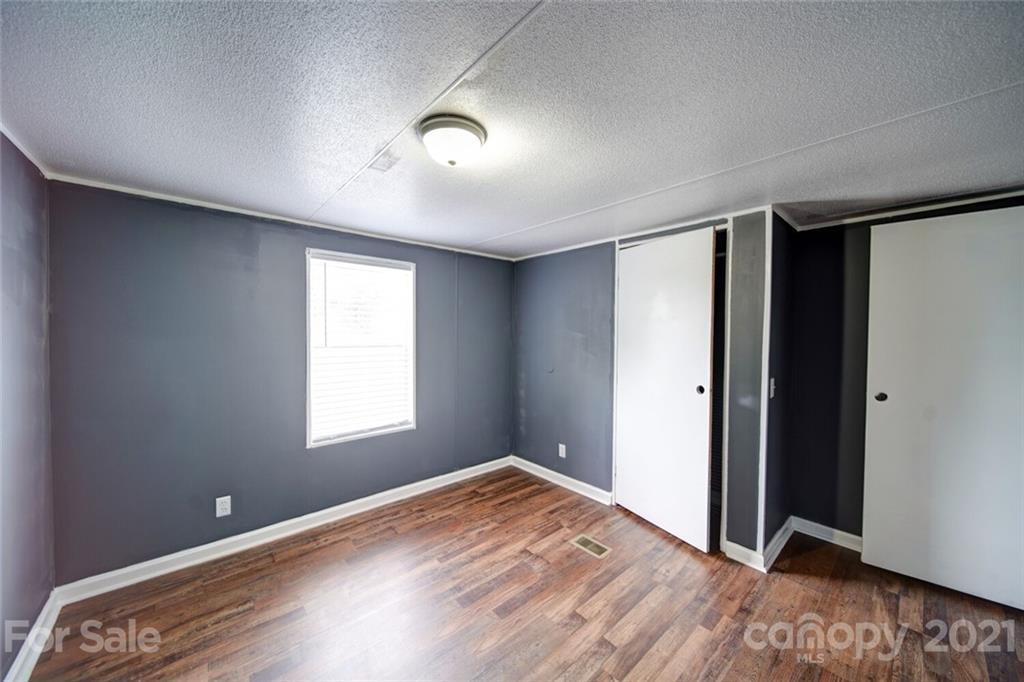 283 Ballard Spring Road, Unit 3276 Morven, NC 28119 - Photo 44 of 48 a view of an empty room with wooden floor and a window