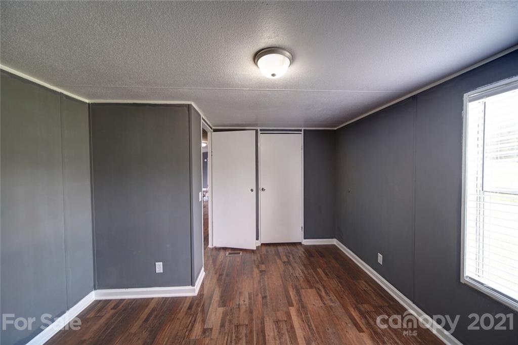 283 Ballard Spring Road, Unit 3276 Morven, NC 28119 - Photo 48 of 48 an empty room with wooden floor and windows