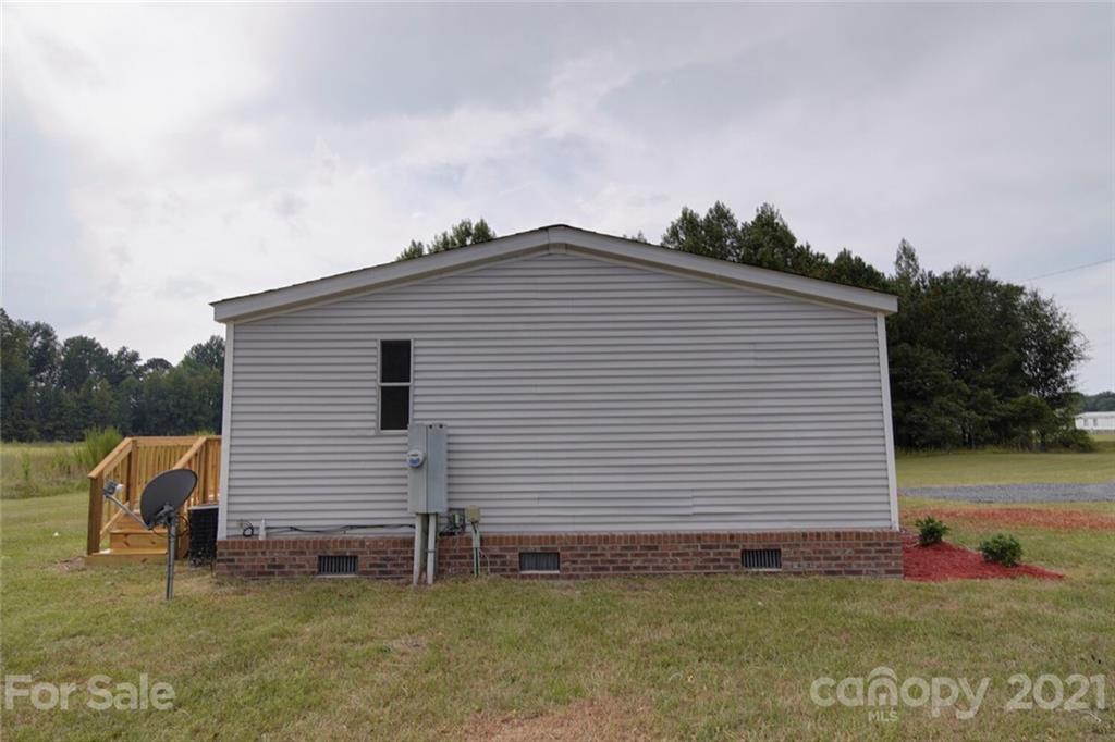 283 Ballard Spring Road, Unit 3276 Morven, NC 28119 - Photo 6 of 48 a backyard of a house with white walls