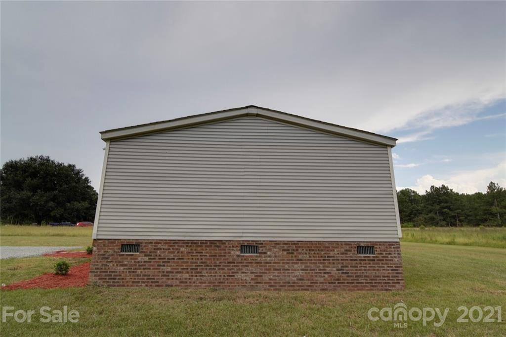 283 Ballard Spring Road, Unit 3276 Morven, NC 28119 - Photo 7 of 48 a front view of a house with a yard