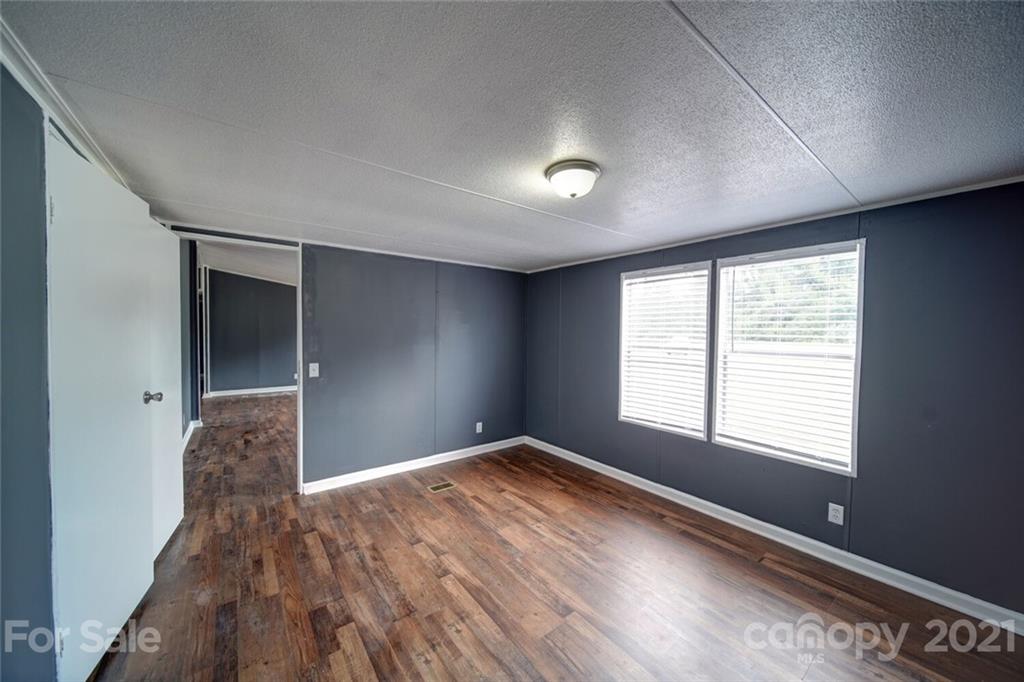 283 Ballard Spring Road, Unit 3276 Morven, NC 28119 - Photo 9 of 48 a view of an empty room with window and wooden floor