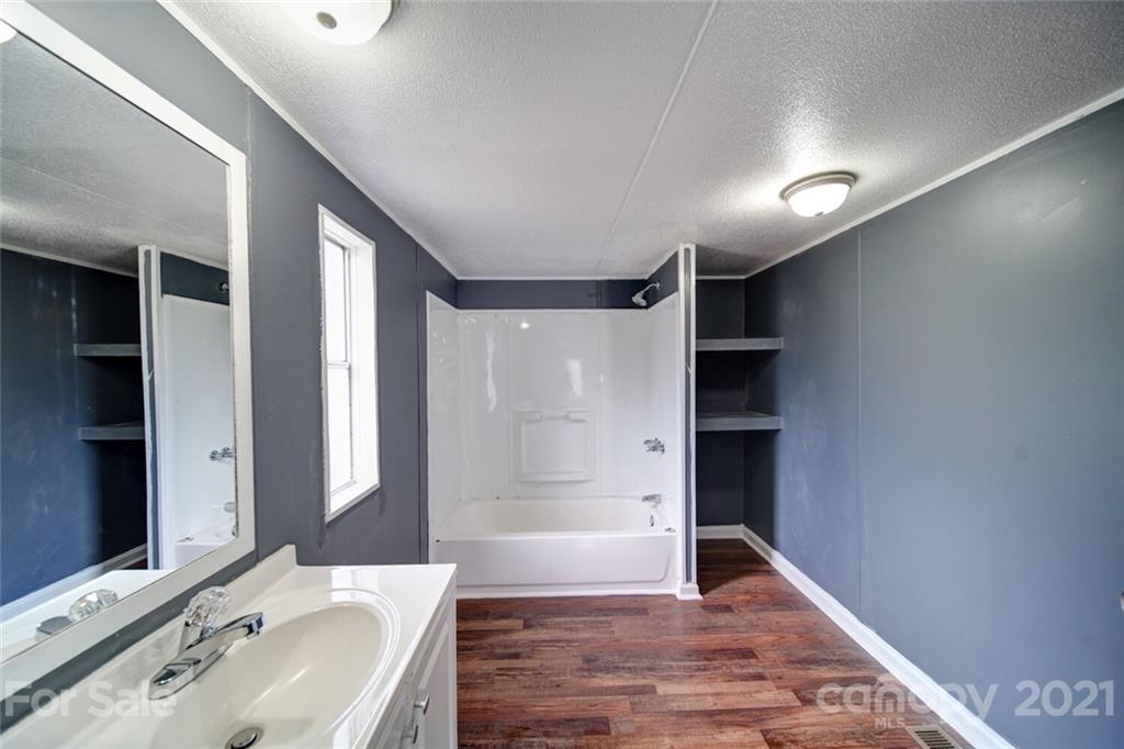 283 Ballard Spring Road, Unit 3276 Morven, NC 28119 - Photo 10 of 48 a bathroom with a sink and a mirror