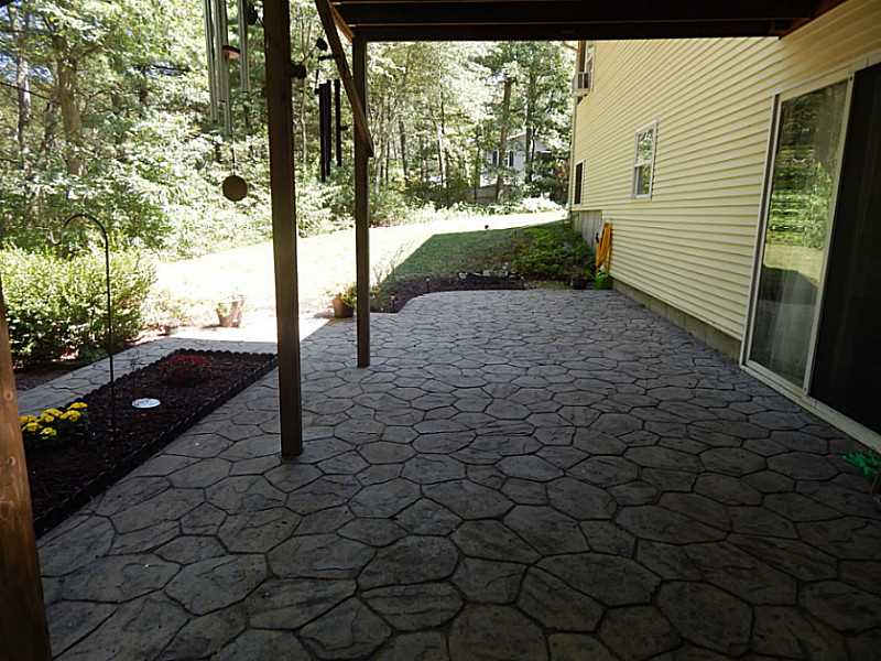 340 Devils Foot Road North Kingstown, RI 02852 - Photo 7 of 24 Exterior Back. Additional stamped concrete patio space under deck.