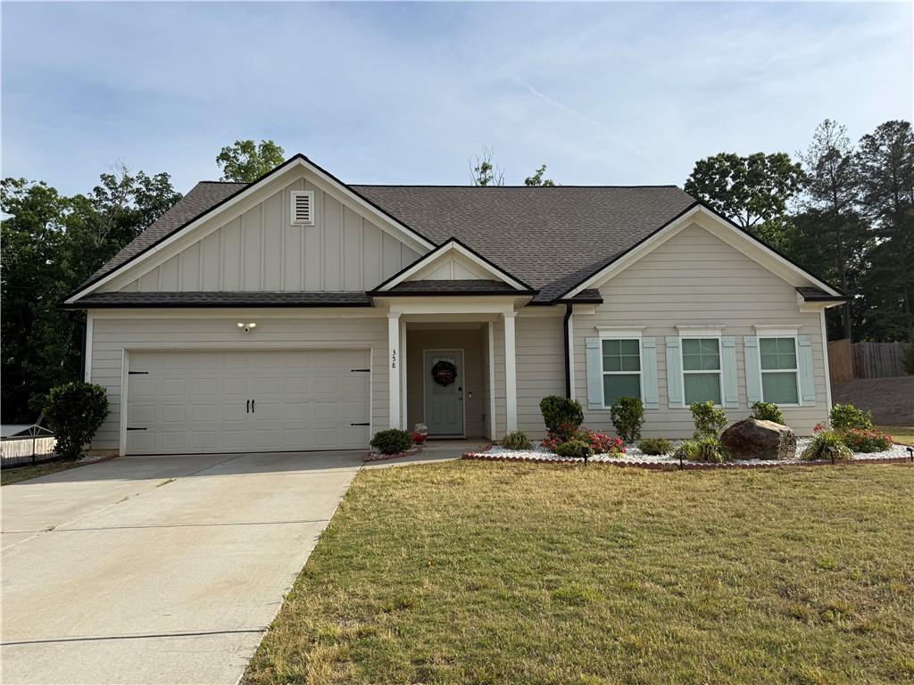 a front view of a house with trees in the background