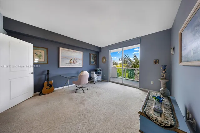 a living room with furniture chess board and a large window