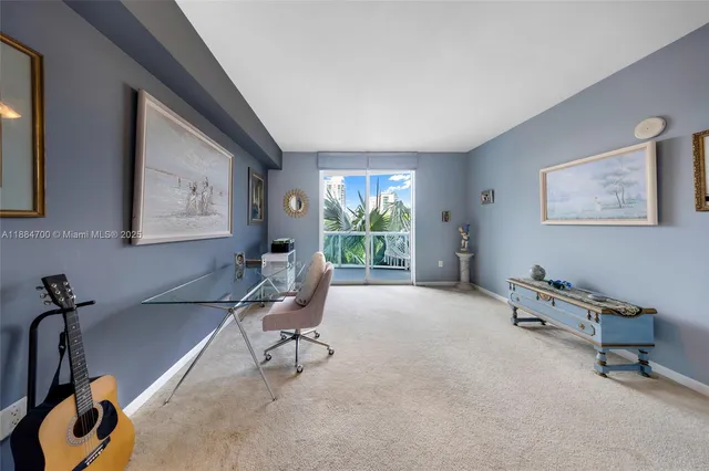 a view of a livingroom with workspace and a window