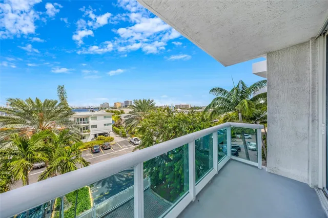a view of balcony with wooden floor and a bench