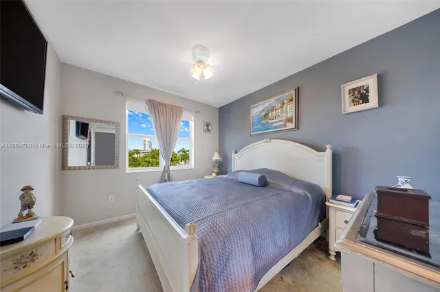 a bed room with a bed and a tv