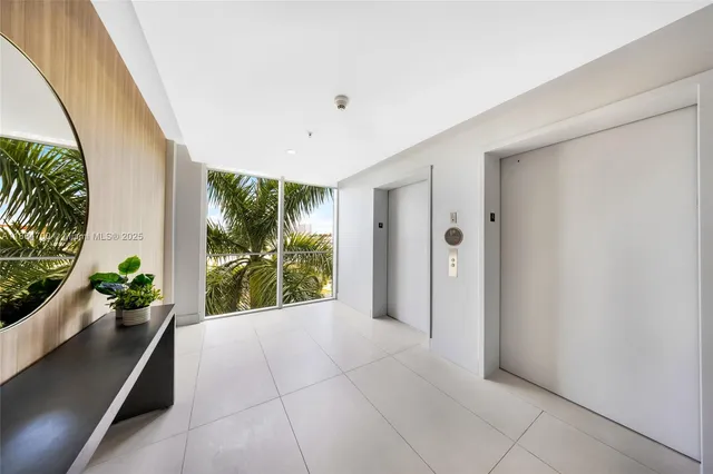 a view of an entryway with wooden floor and a potted plant