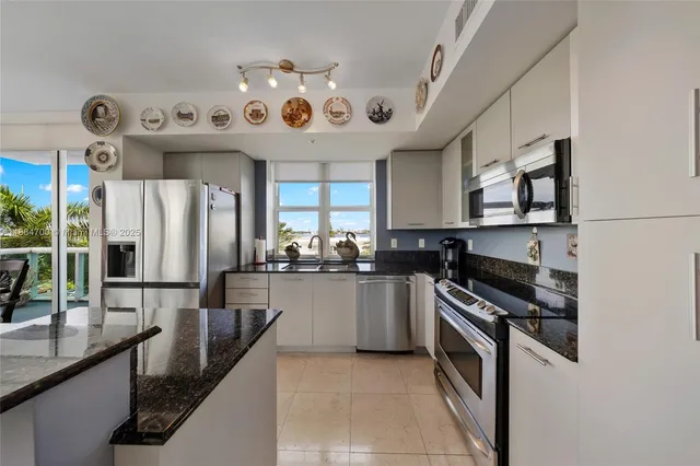 a kitchen with a sink stainless steel appliances and cabinets