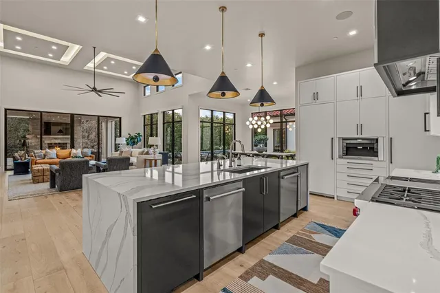 a kitchen with stainless steel appliances kitchen island granite countertop a sink and cabinets