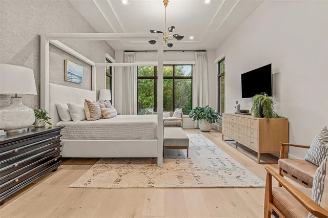 a bedroom with a bed and glass window