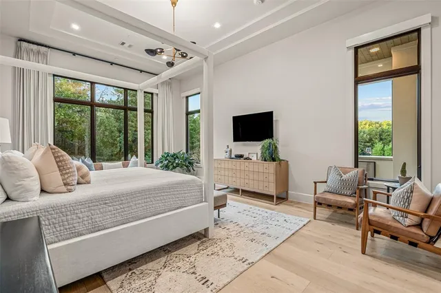 a large white kitchen with a large window