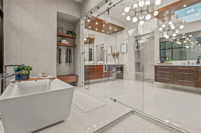 a bathroom with a granite countertop sink a large mirror and a shower