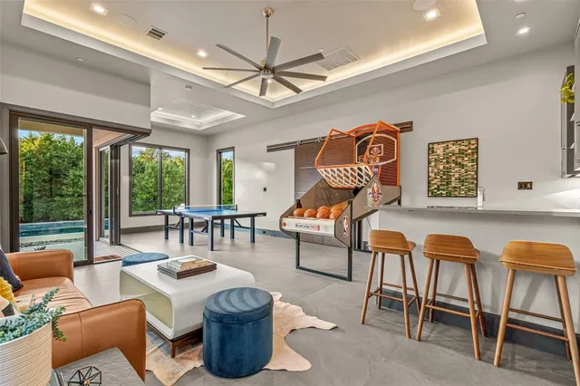 a living room with furniture a ceiling fan and a window