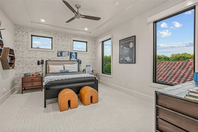 a bedroom with a bed and a wall painting