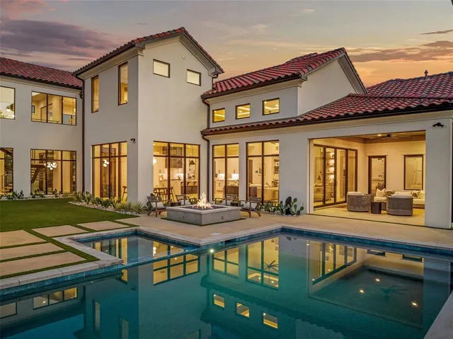 an aerial view of residential houses with outdoor space and trees
