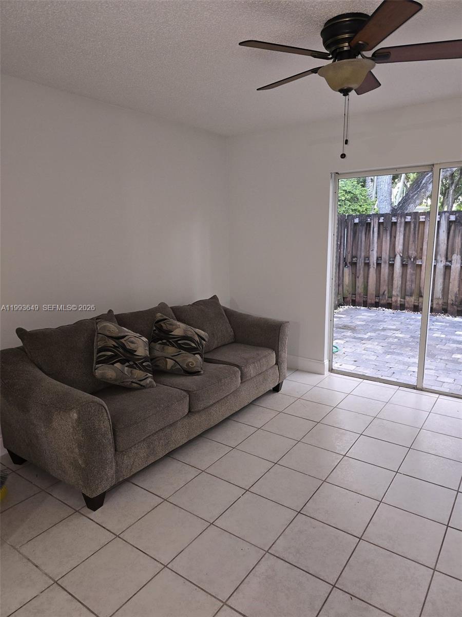 14272 Southwest 121st Place, Unit 9 Miami, FL 33186 - Photo 1 of 17 a living room with a couch