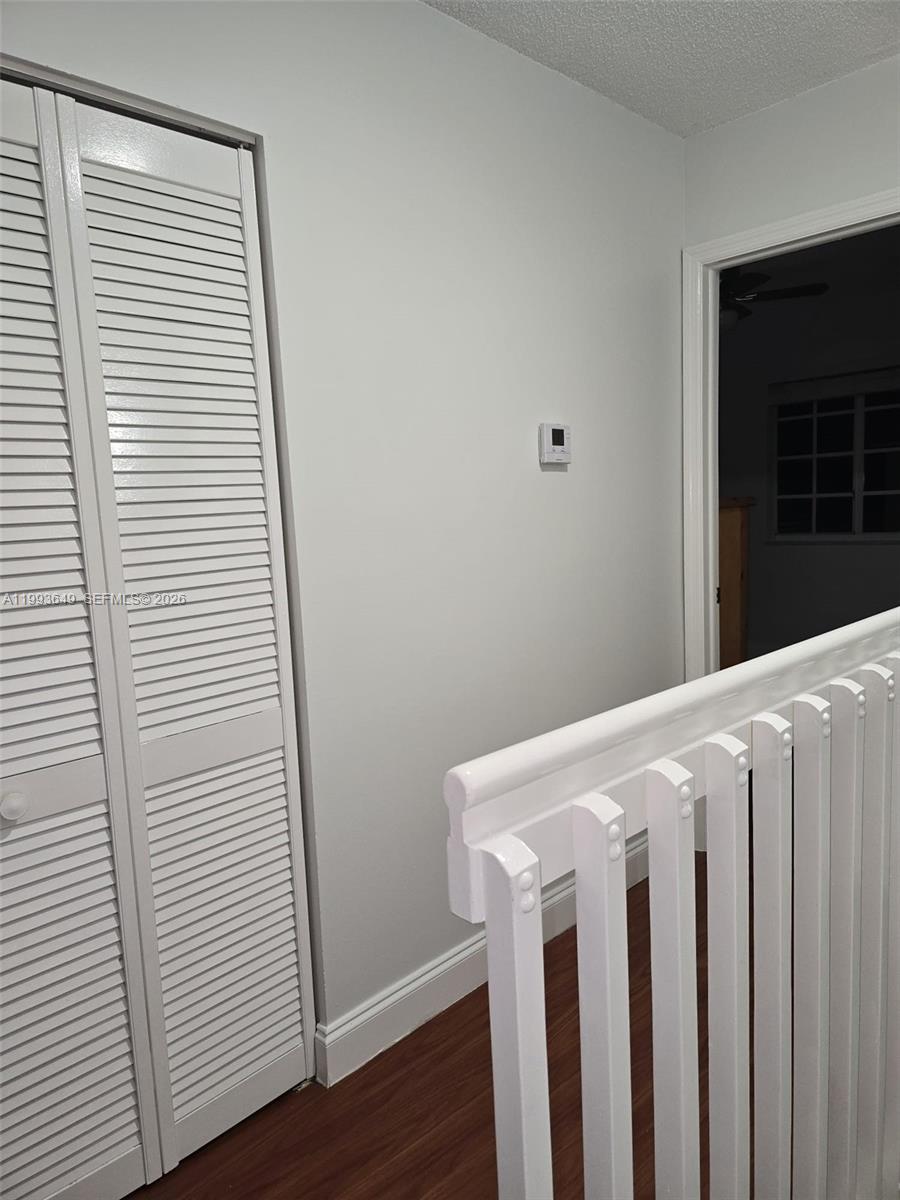 14272 Southwest 121st Place, Unit 9 Miami, FL 33186 - Photo 12 of 17 a view of a white house with wooden floor