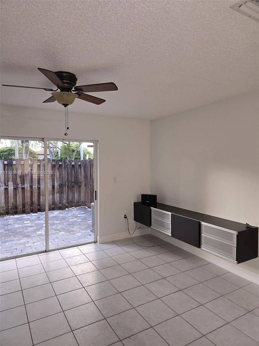 14272 Southwest 121st Place, Unit 9 Miami, FL 33186 - Photo 2 of 17 a view of an empty room and a ceiling fan