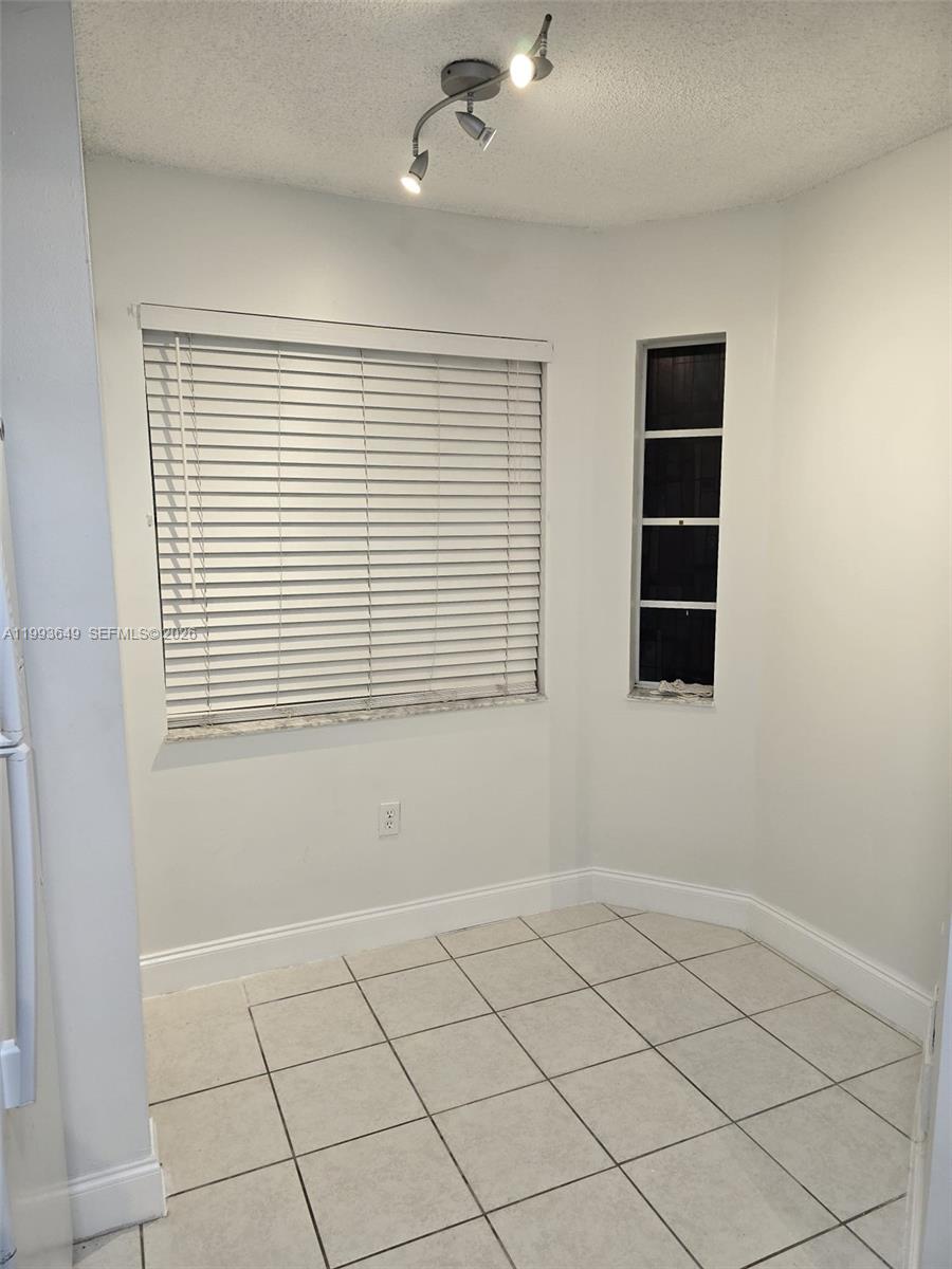 14272 Southwest 121st Place, Unit 9 Miami, FL 33186 - Photo 3 of 17 a view of an empty room with a window