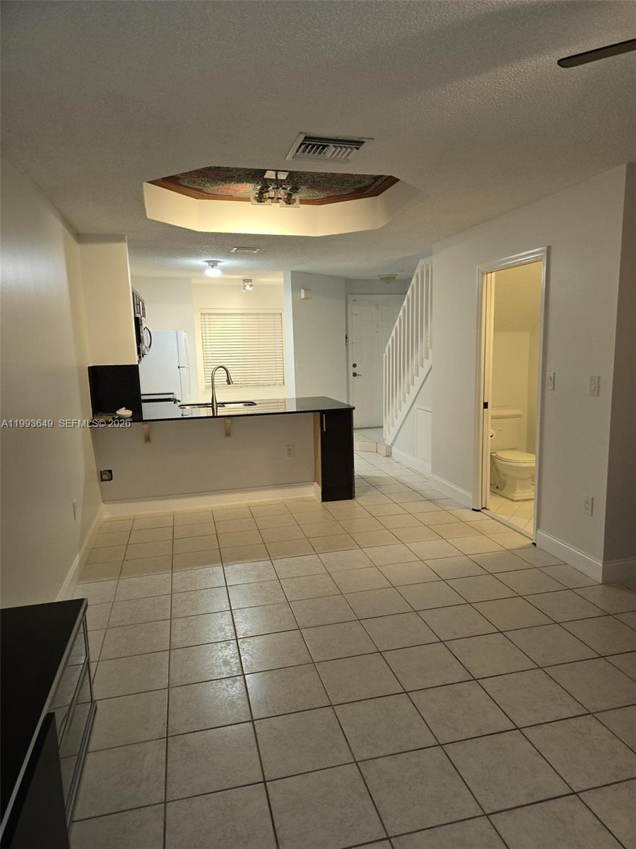14272 Southwest 121st Place, Unit 9 Miami, FL 33186 - Photo 5 of 17 a view of a kitchen with a sink and cabinets