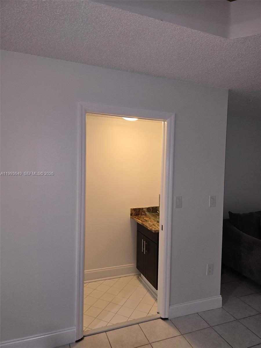 14272 Southwest 121st Place, Unit 9 Miami, FL 33186 - Photo 10 of 17 a view of a kitchen with storage and utility