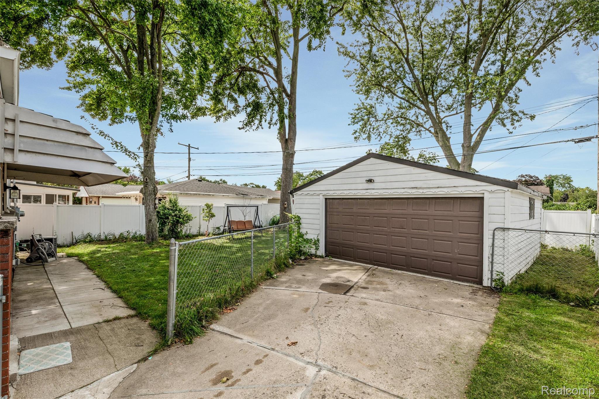 9522 Pardee Road Taylor, MI 48180 - Photo 22 of 25 Detached garage with a brown panel door, concrete driveway, and side access