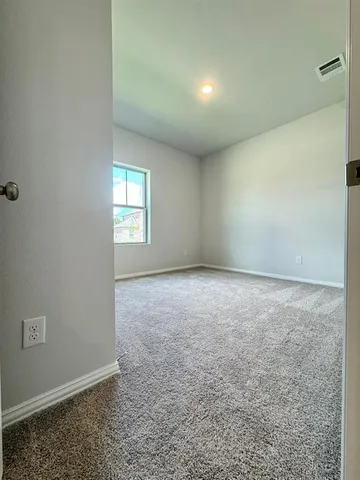 an empty room with a empty space and windows