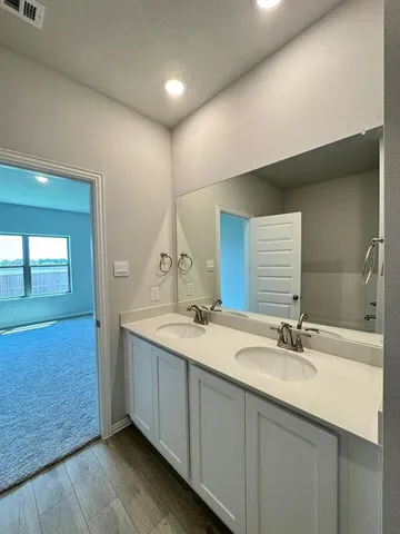 a bathroom with a double vanity sink and mirror