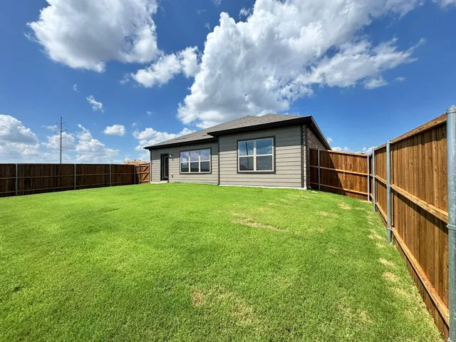 a view of field with grass and a big yard