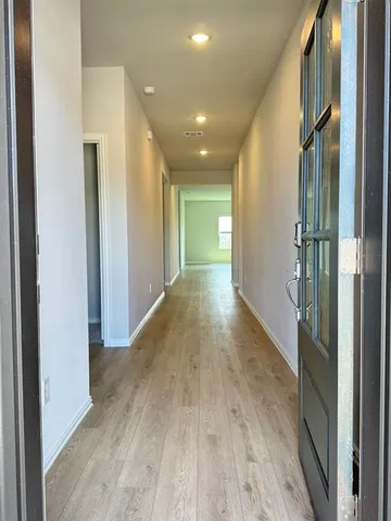 a view of hallway with wooden floor