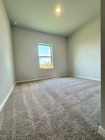 an empty room with a empty space and windows