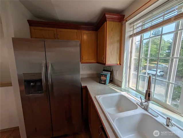 a kitchen with a refrigerator and a sink
