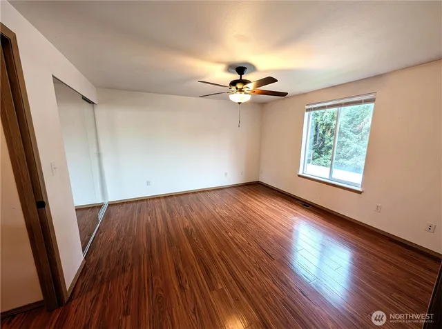 wooden floor in an empty room with a window
