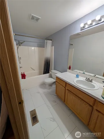 a bathroom with a double vanity sink a mirror and a shower
