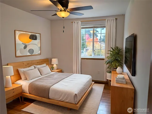 a bedroom with a bed and a flat screen tv