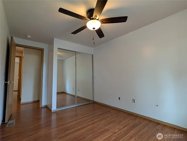 a view of an empty room with wooden floor