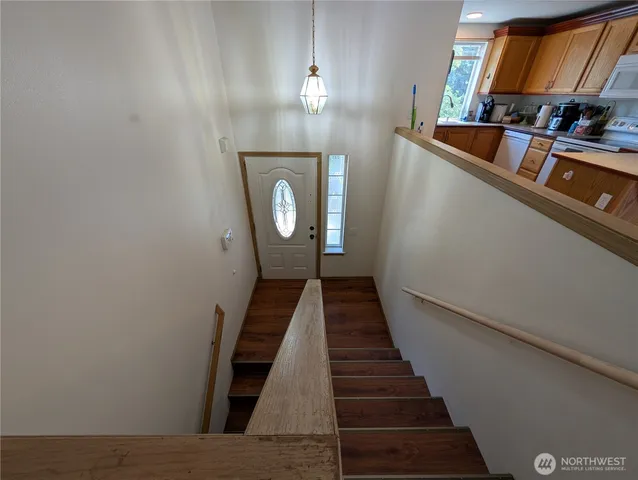 a view of entryway and hall with wooden floor