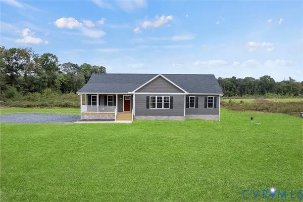 a aerial view of a house next to a yard