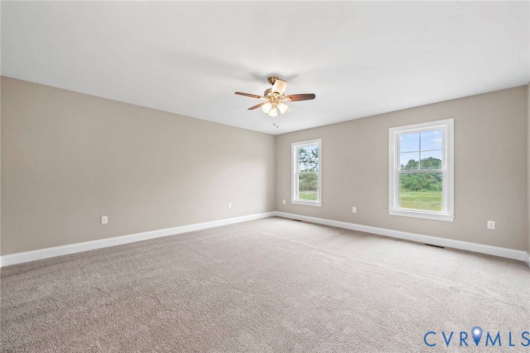 531 Salem Church Road Cumberland, VA 23040 - Photo 13 of 26 an empty room with a window and a ceiling fan