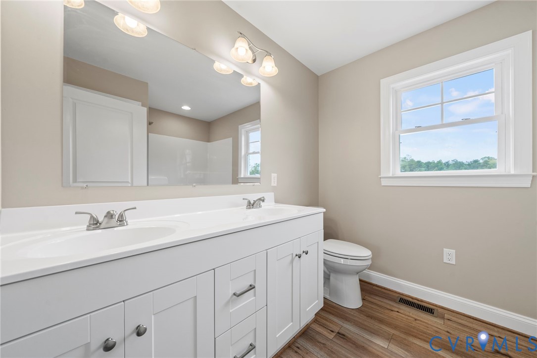 531 Salem Church Road Cumberland, VA 23040 - Photo 16 of 26 a bathroom with a toilet sink and mirror