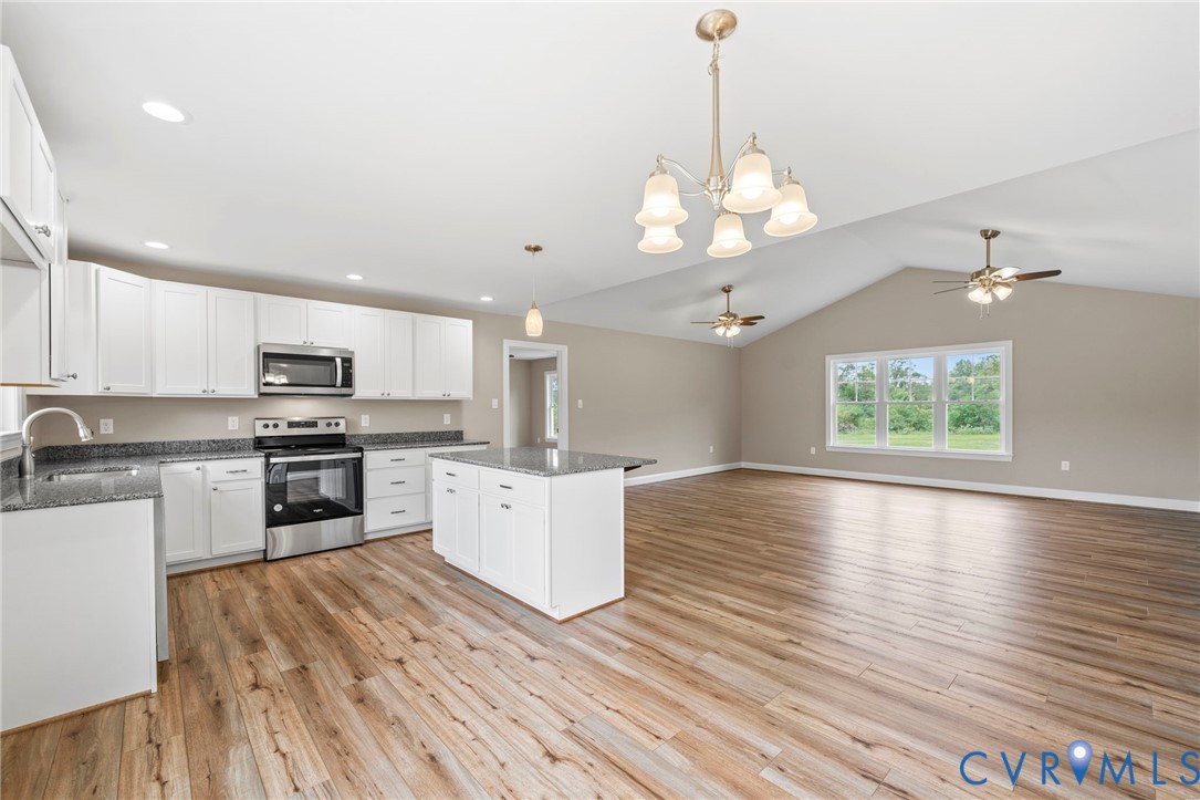 531 Salem Church Road Cumberland, VA 23040 - Photo 7 of 26 a open kitchen with white cabinets a sink dishwasher and a stove with wooden floor
