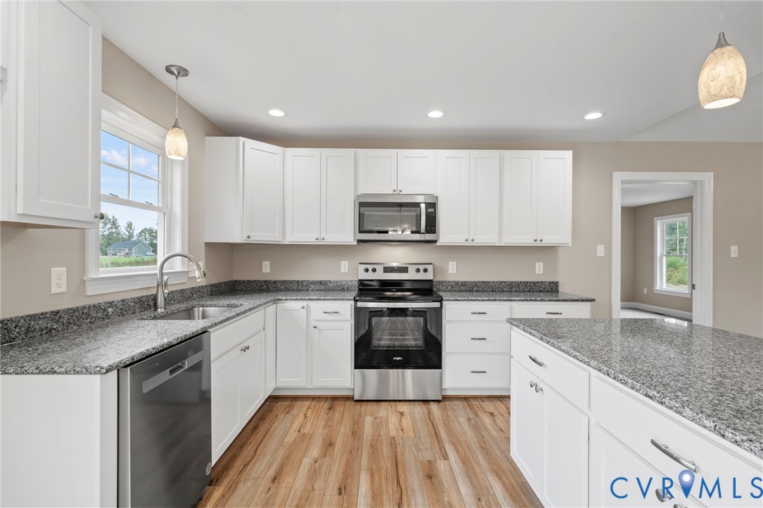 531 Salem Church Road Cumberland, VA 23040 - Photo 8 of 26 a kitchen with granite countertop white cabinets and white appliances