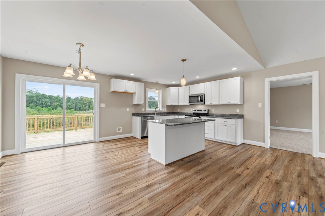 531 Salem Church Road Cumberland, VA 23040 - Photo 10 of 26 a kitchen with wooden floors and white cabinets